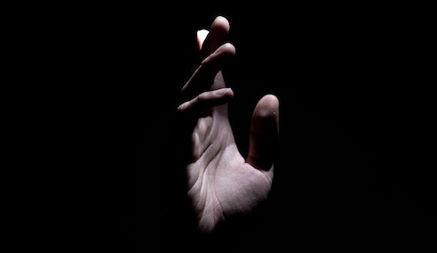 Hand reaching out of the darkness