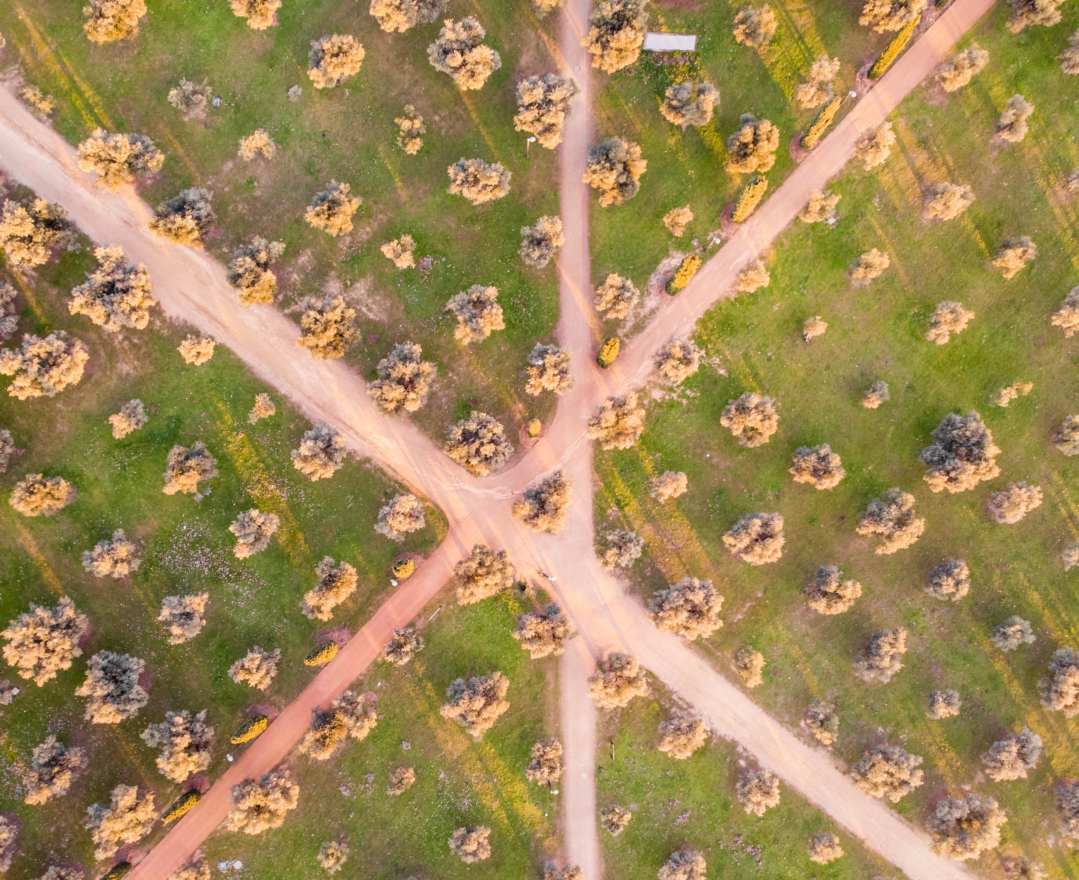 Top down view from the sky of dirt roads intersecting